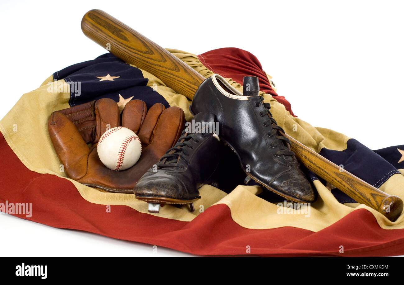 Vintage baseball equipment including cleats, mitt, ball and bat on a flag bunting Stock Photo