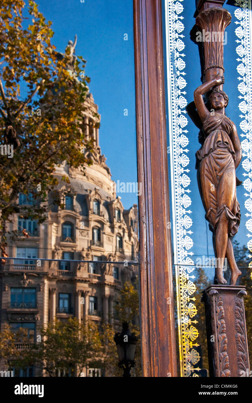 Architecture along Barcelona's Paseo de Gracia reflecting in window Stock Photo