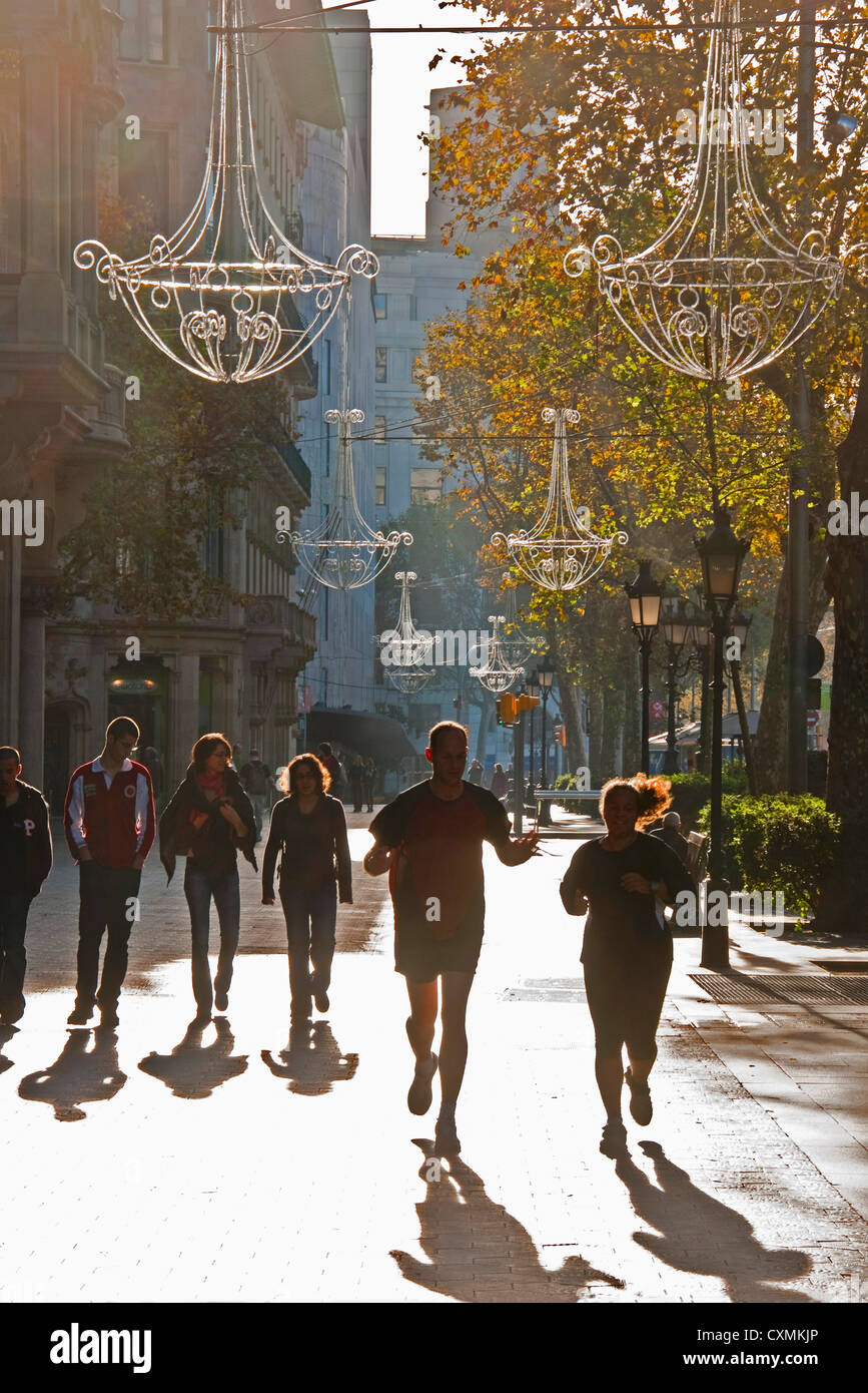Barcelona's Paseo de Gracia with Sunday joggers and strollers in autumn Stock Photo