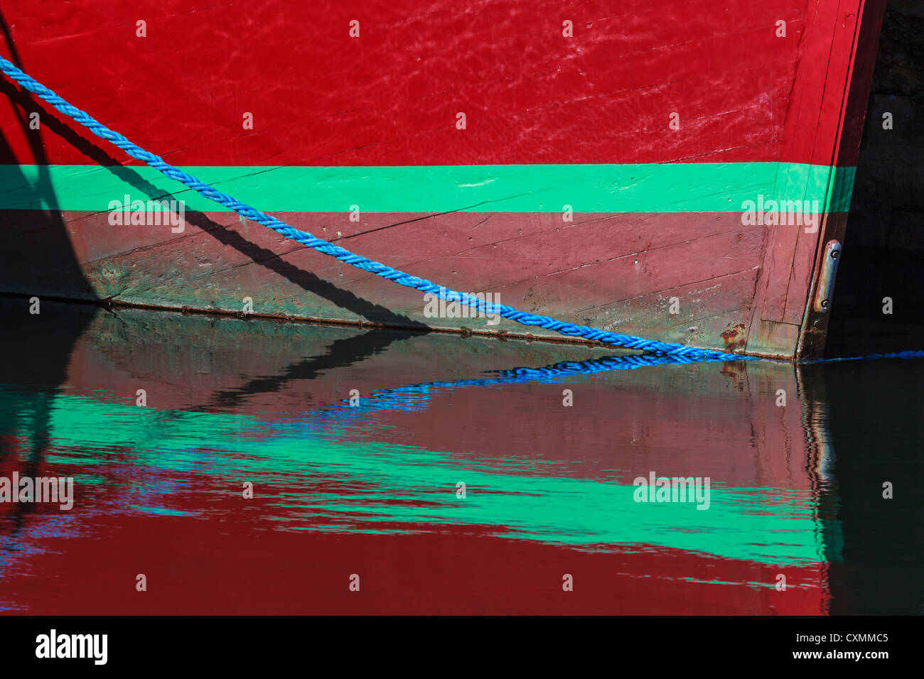 Boat and reflection with mooring rope Stock Photo