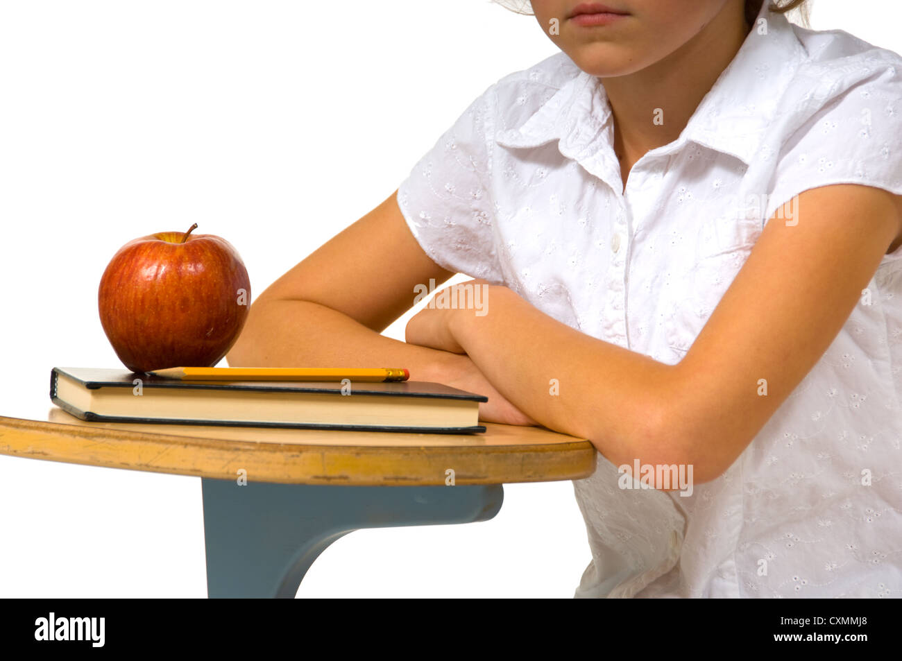 young girl at School desk with apple on white background Stock Photo ...