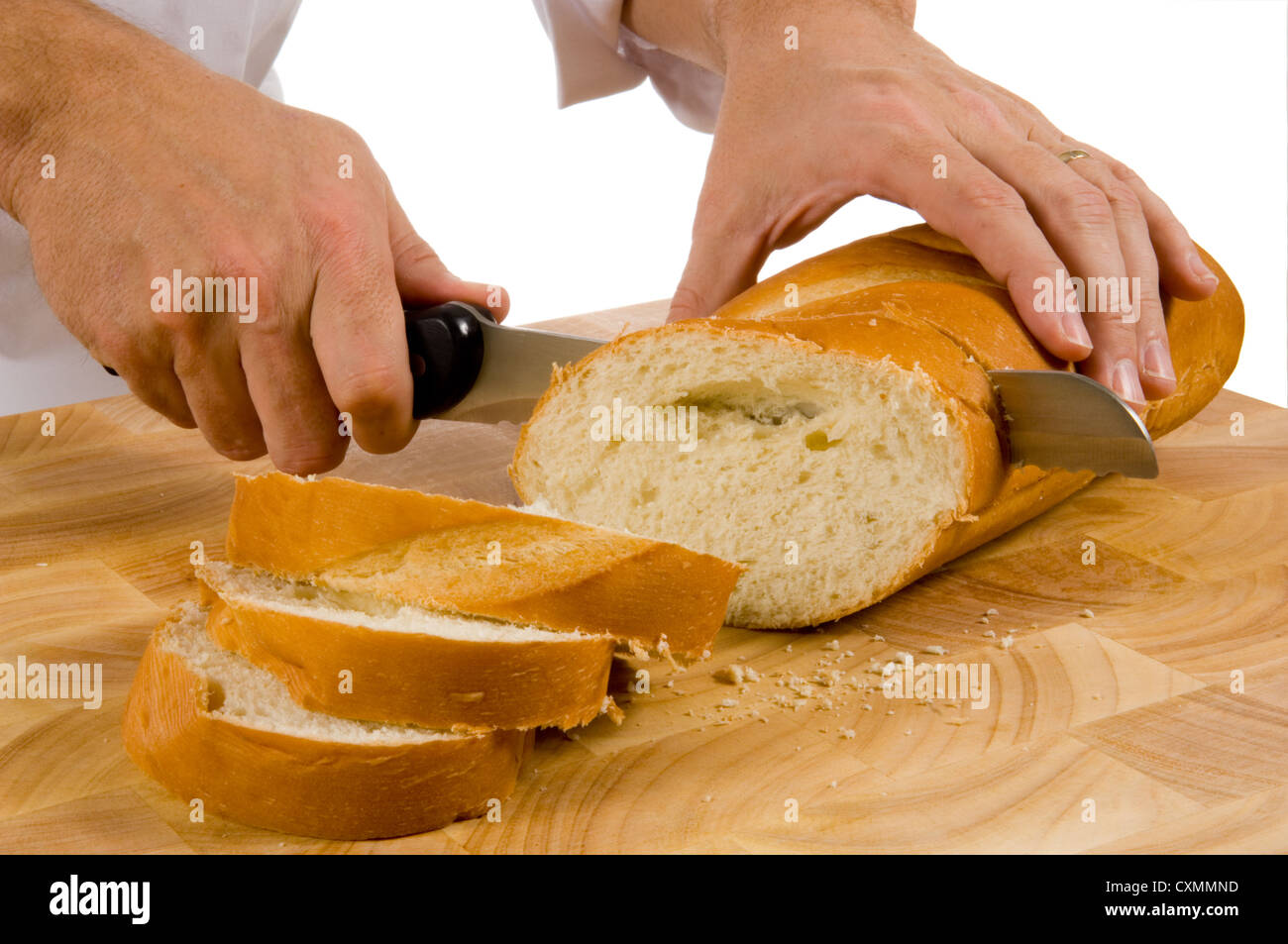 slicing bread on wood cutting board with a bread knife Stock Photo Alamy
