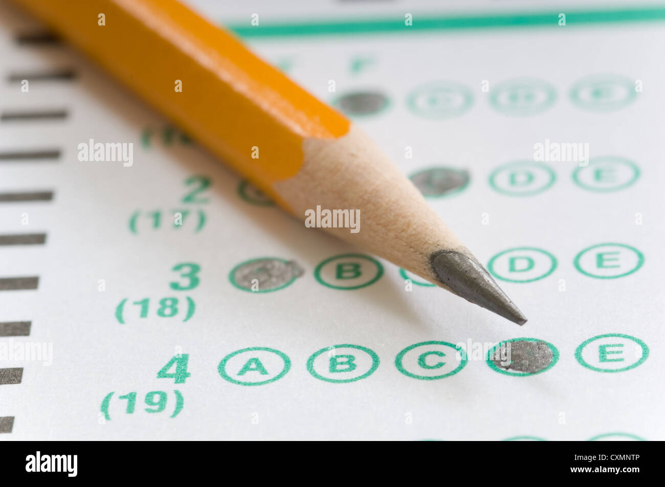 Yellow pencil on multiple choice test computerized answer sheet - focus is on the letter D in answer number 4 Stock Photo