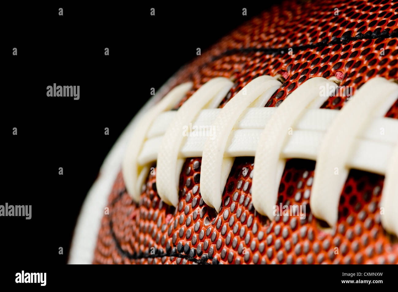 Brown leather American football on black background Stock Photo Alamy