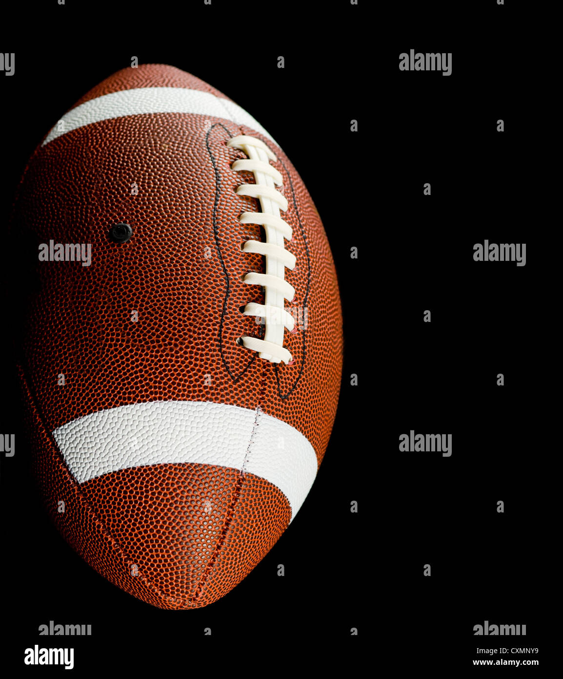 Brown leather American football on black background Stock Photo Alamy