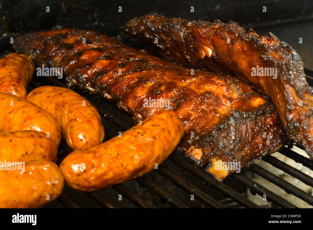 Pork ribs and sausage on a grill Stock Photo