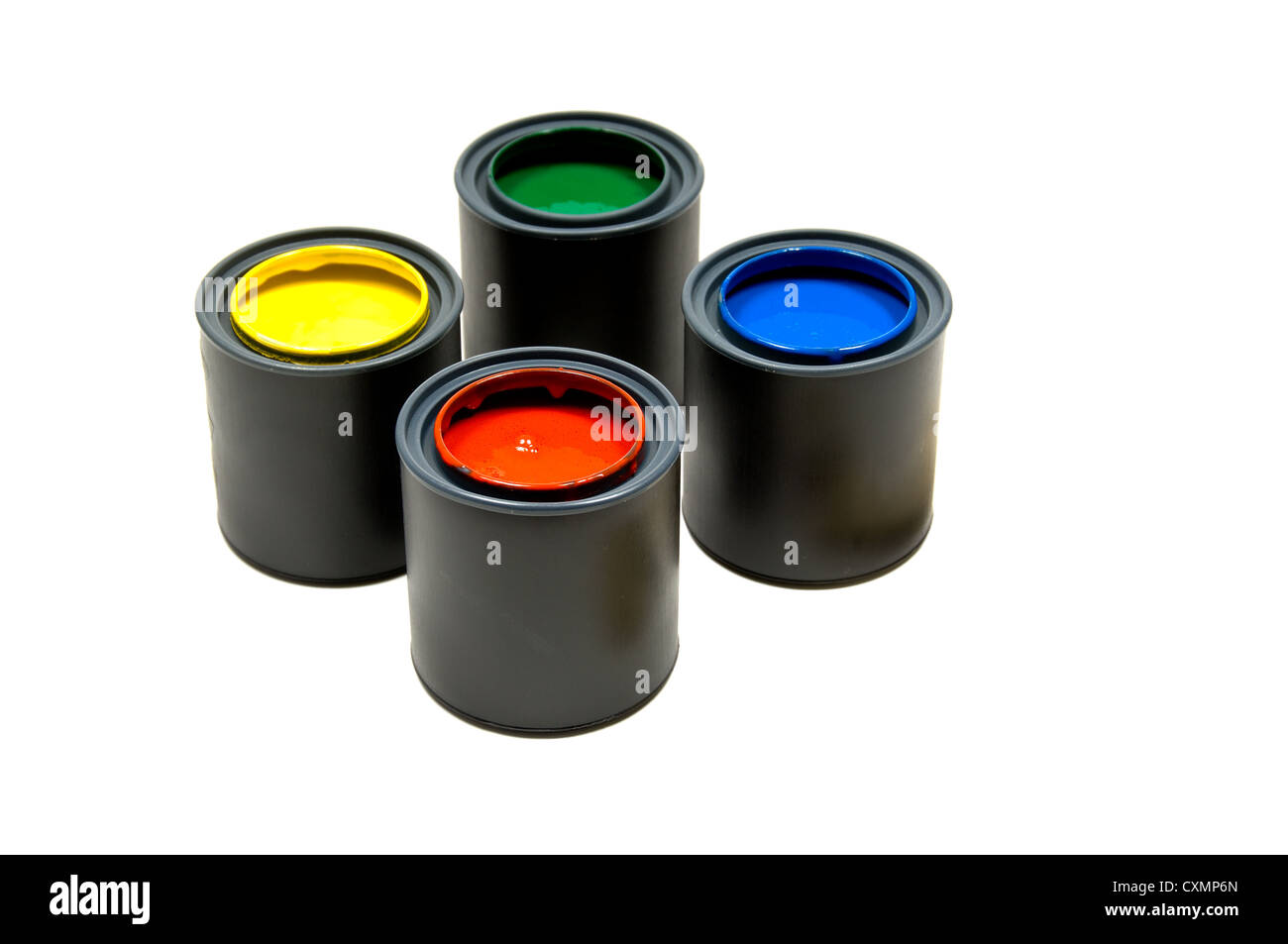Four cans of primary colored paints on a white background, including yellow, green, blue and red Stock Photo