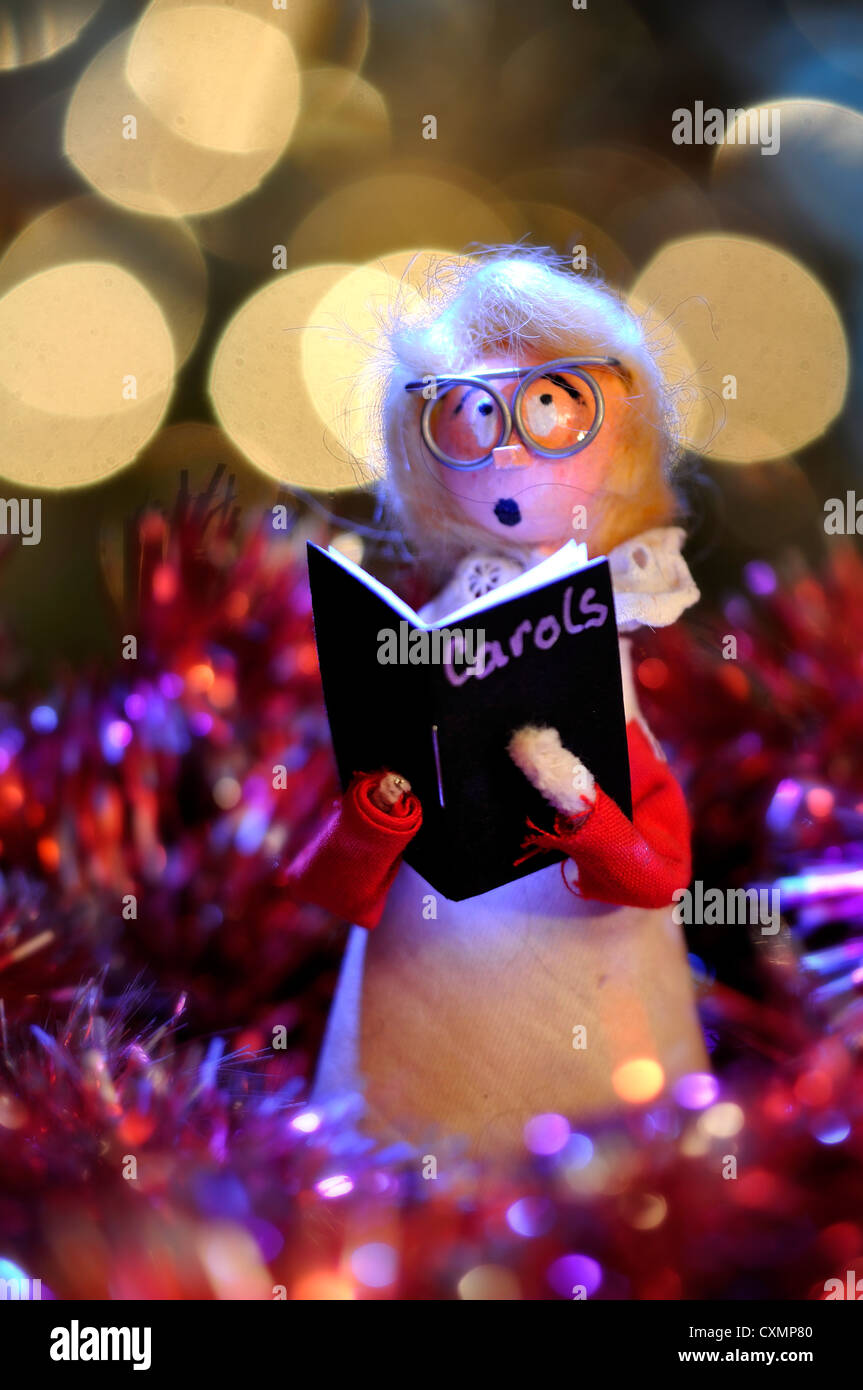 A model choir boy surrounded by tinsel - a Christmas decoration UK Stock Photo