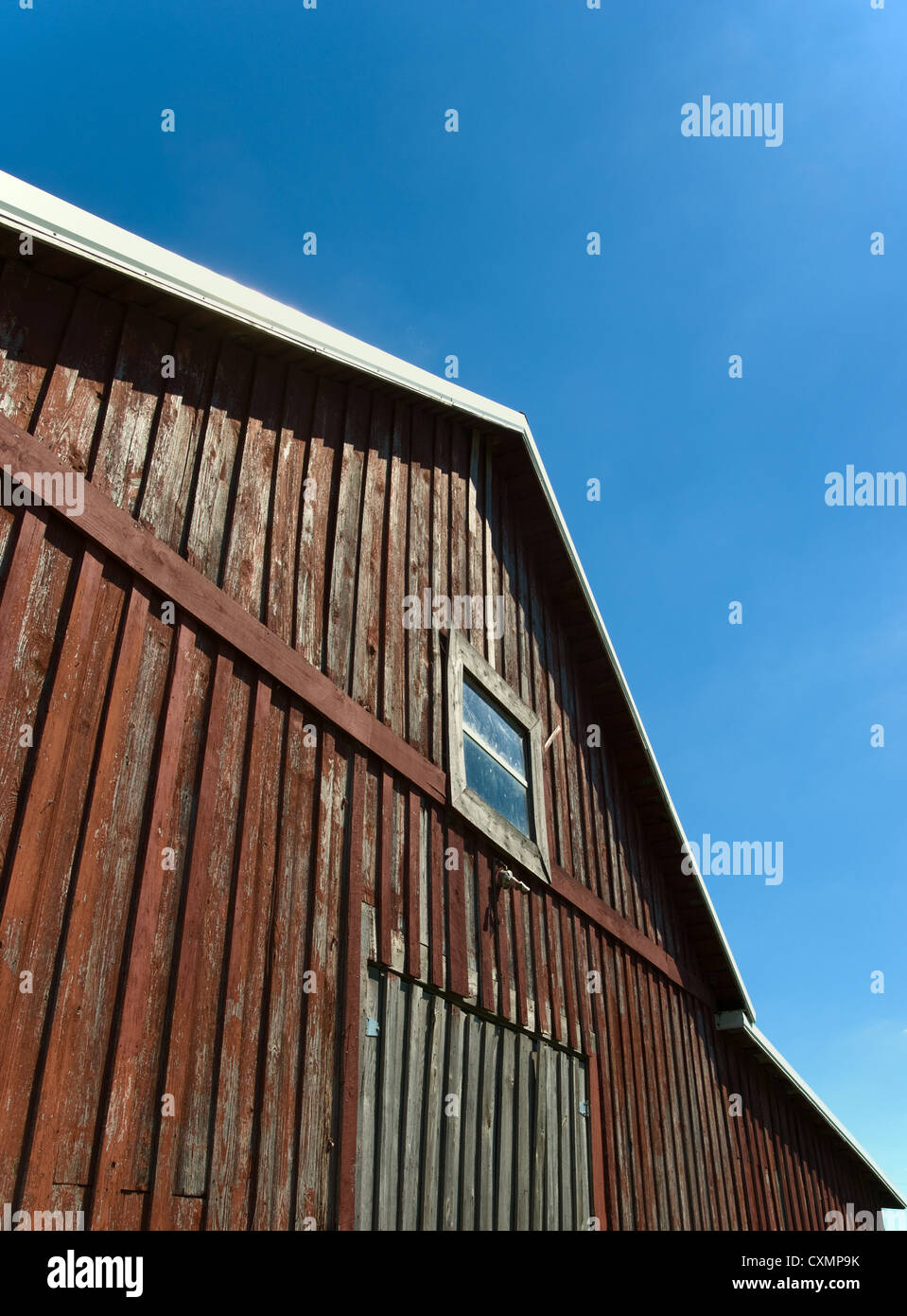 Old red barn against blue sky with window Stock Photo - Alamy
