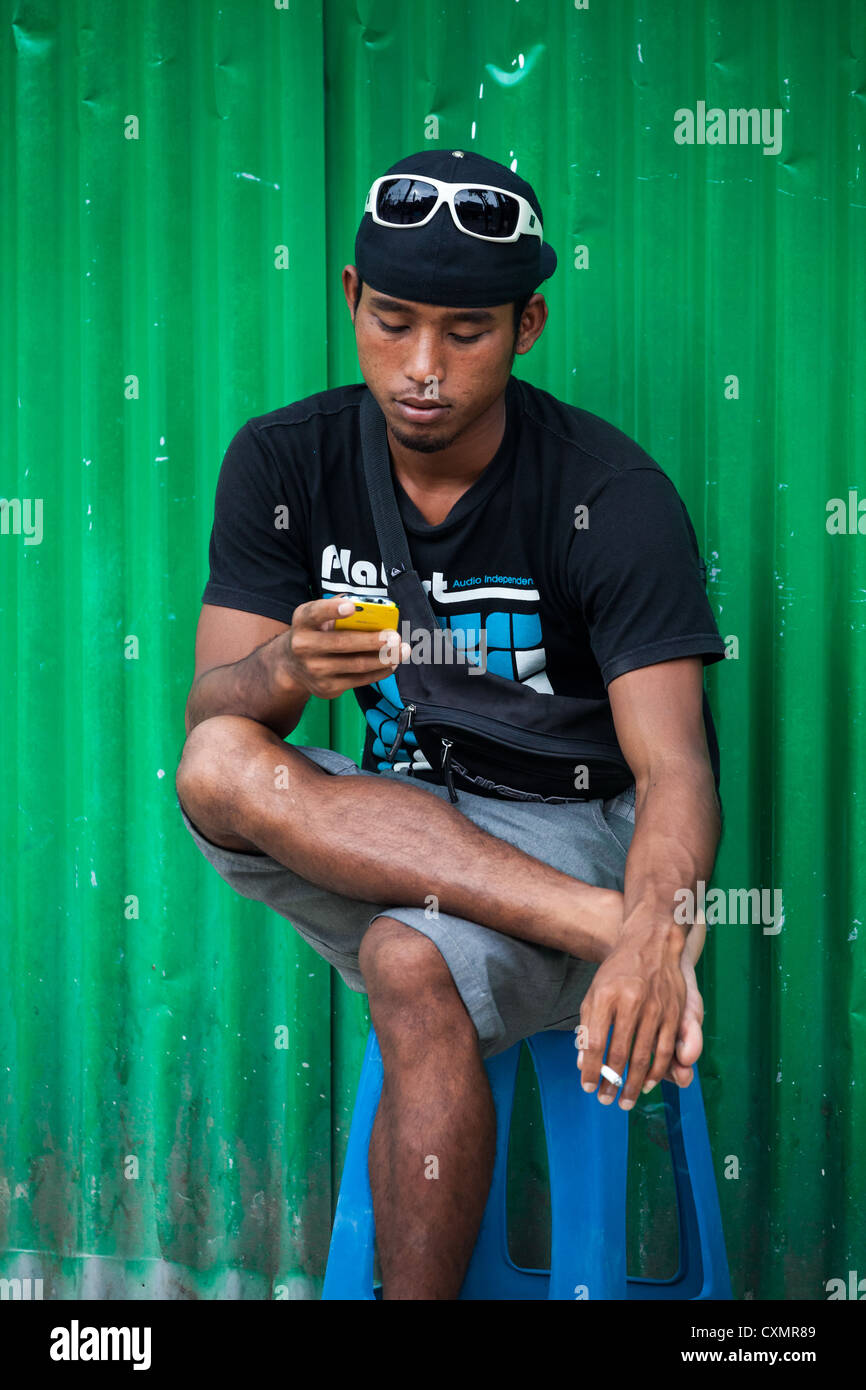 Man with Phone in Kuta on Bali Stock Photo