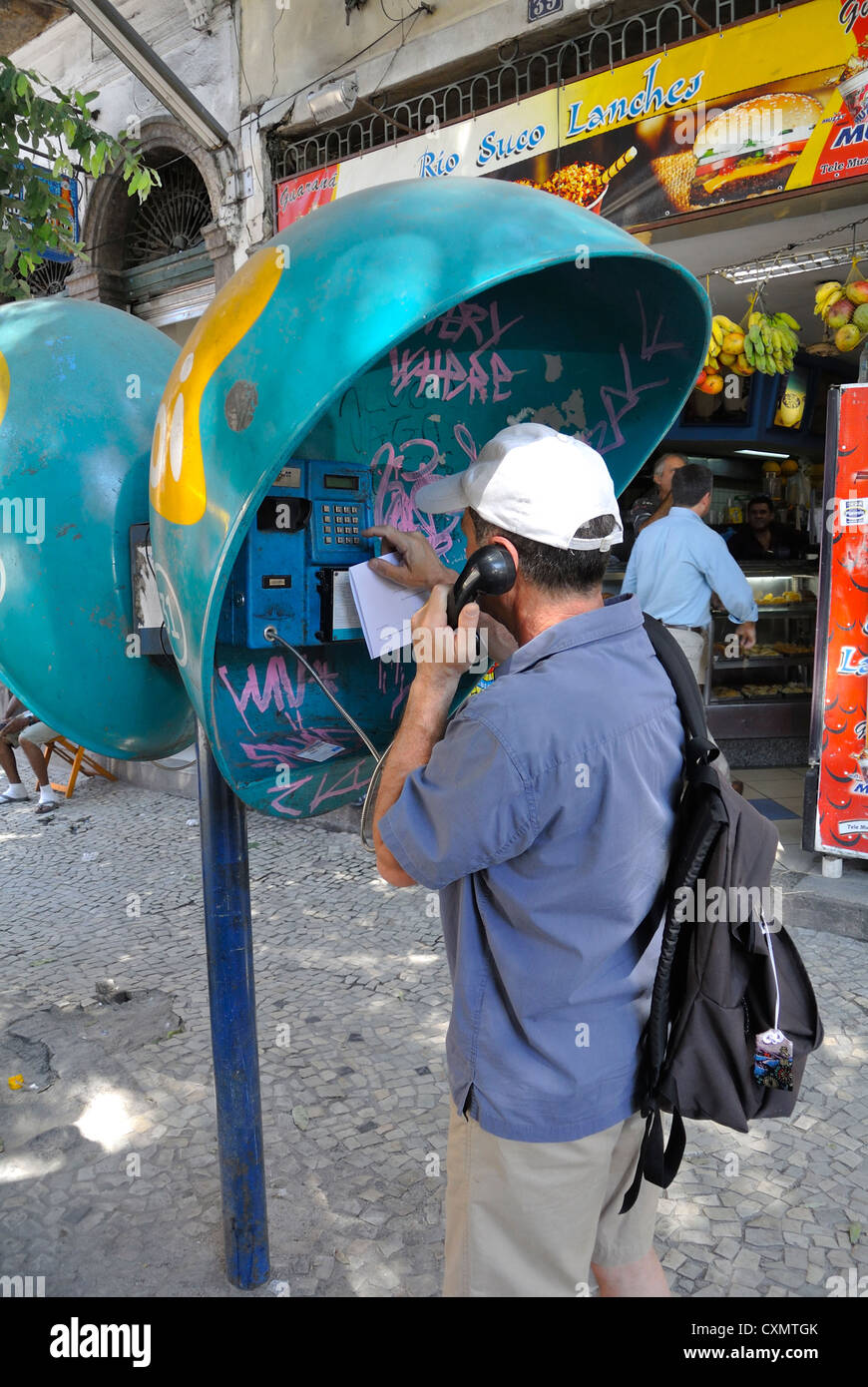 Rio de Janeiro,  Brazil, South America, man at Orelhao which is a local telephone booth Stock Photo