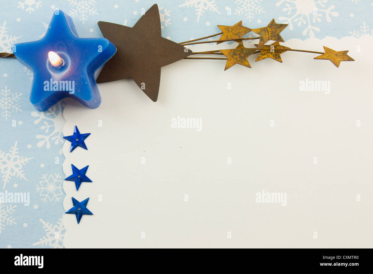 blank Christmas card with blue star candle, metallic stars, rusty stars, and copyspace Stock Photo