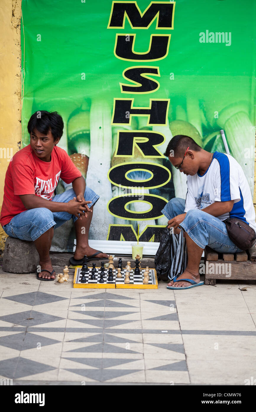 Men playing Chess in the Street in Kuta on Bali Stock Photo