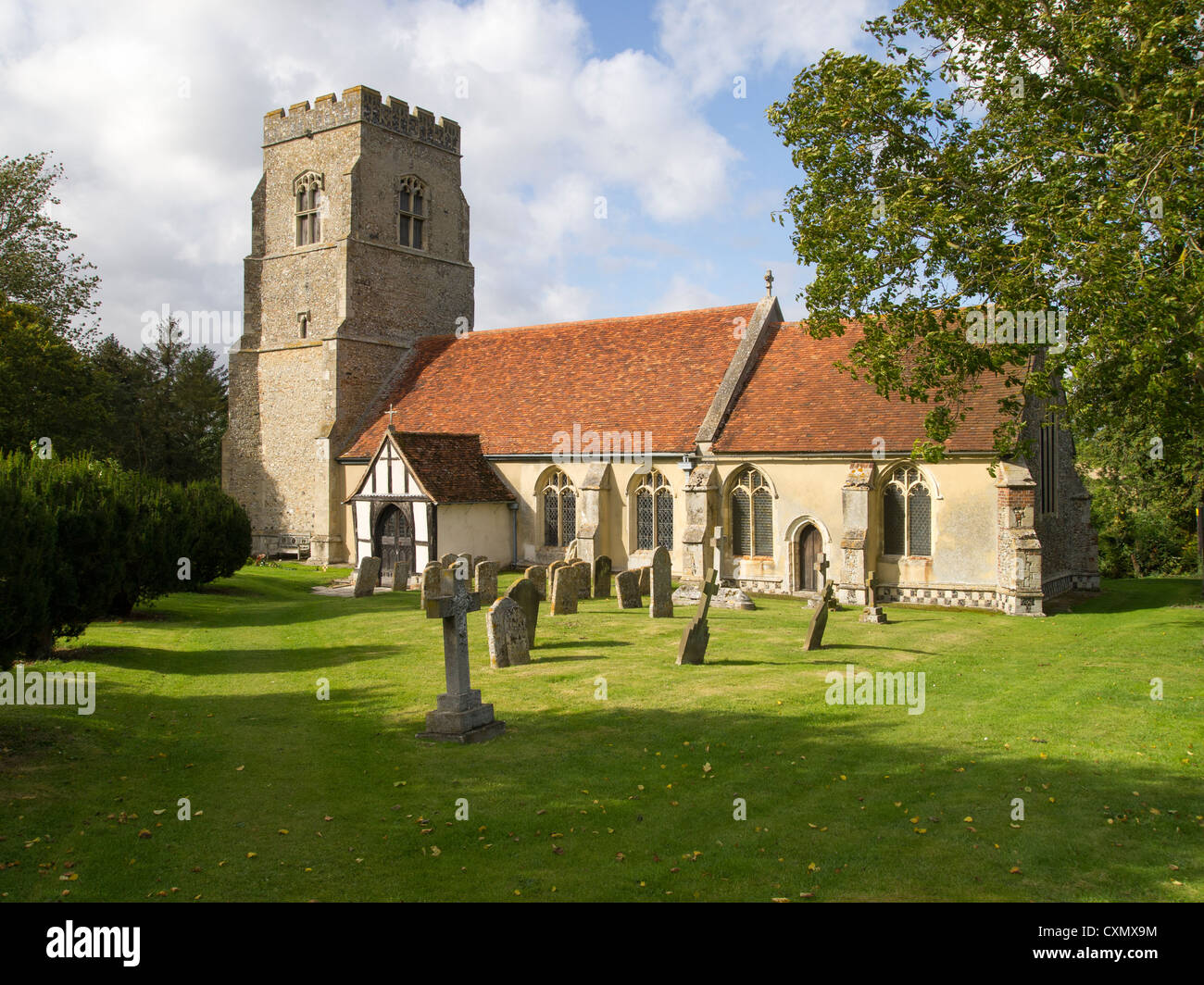 The old church of St Peter and St Paul at Alpheton, Suffolk, pictured in its rural country setting, with graveyard. Stock Photo