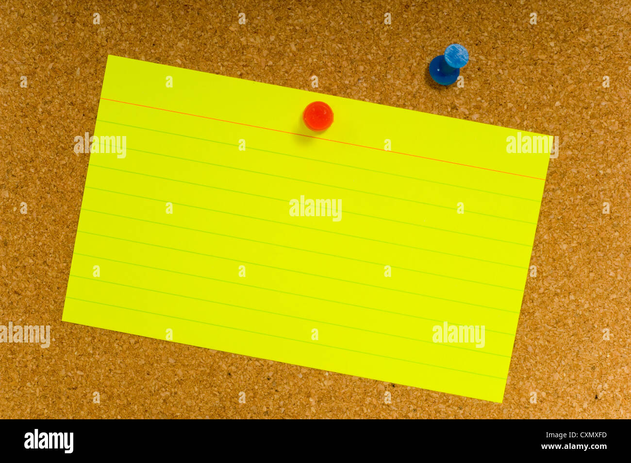 Bright, blank neon colored notecards on brown corkboard or bulletin ...