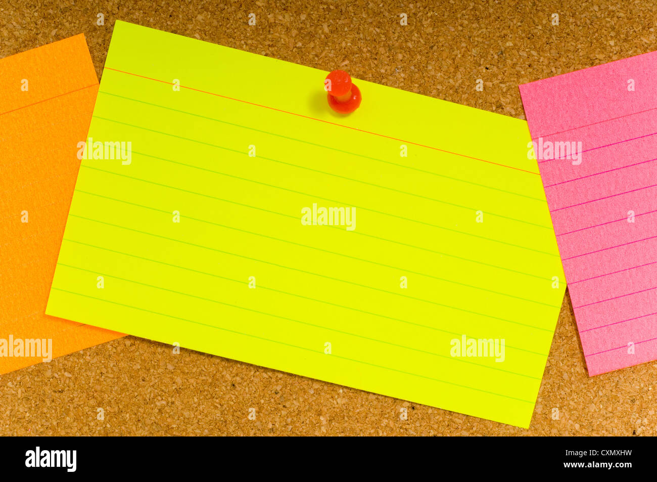 Bright, blank neon colored notecards on brown corkboard or bulletin board  with plastic pushpins, space for copy Stock Photo - Alamy