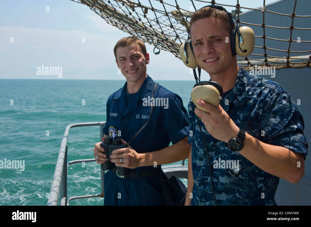 STRAIT OF MALACCA (Oct. 6, 2012) - Seaman Nicholas Fisher, left, and Seaman Abel Cardona stand fantail watch. The two watch standers reported man overboard for an Malaysian fisherman floating in the Strait of Malacca. Stennis is returning to the U.S. 7th and 5th Fleets areas of responsibility for months ahead of schedule in order to maintain combatant requirements for the presence in the region. Stock Photo