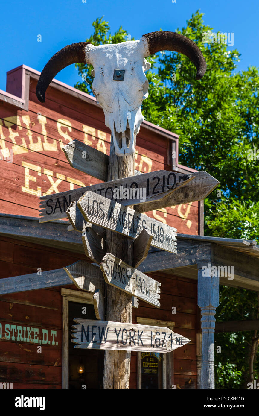 Signpost showing distances to major US cities in '1880 Town' western attraction in Murdo, South Dakota, USA Stock Photo