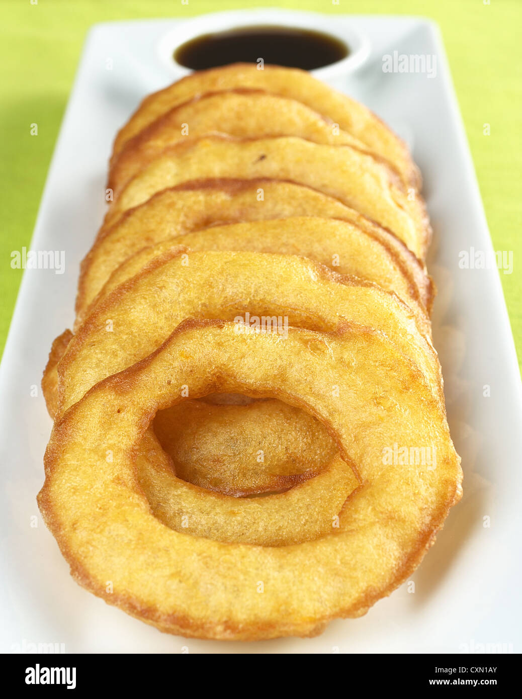 Popular Peruvian dessert called Picarones made from squash and sweet potato and served with Chancaca syrup (kind of honey) Stock Photo