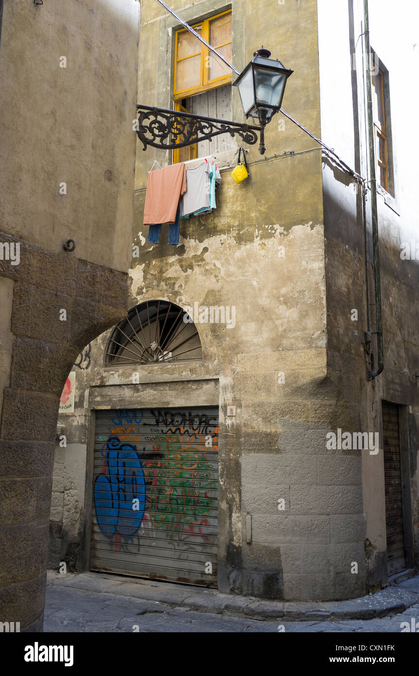 Typical street scene with laundry drying, shutters and shadows in Florence, Tuscany, Italy Stock