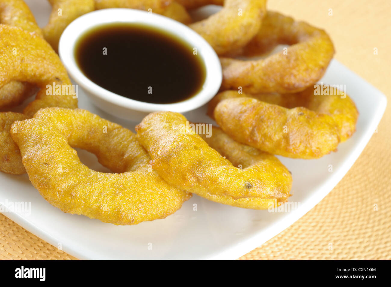 Popular Peruvian dessert called Picarones made from squash and sweet potato and served with Chancaca syrup (kind of honey) Stock Photo