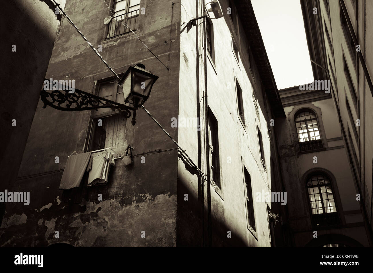Typical street scene with laundry drying, shutters and shadows in Florence, Tuscany, Italy Stock