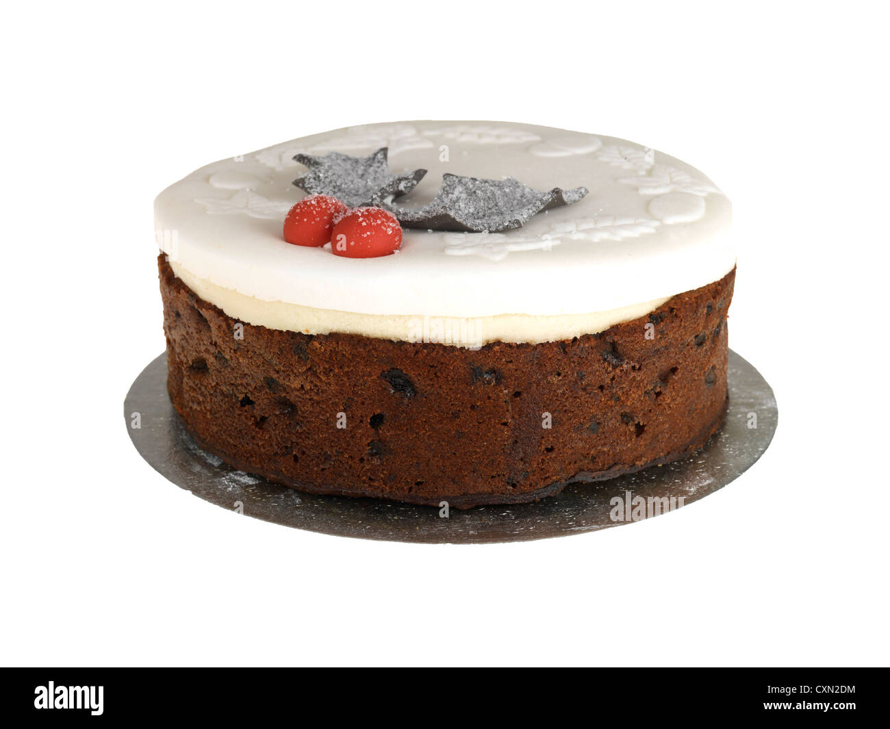Traditional Festive Season Christmas Cake With White Icing Holly And Berries Decoration Against A White Background With No People Stock Photo