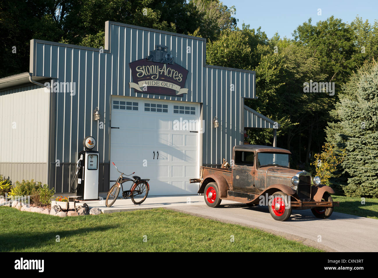 Old Ford truck in front of garage. Stock Photo