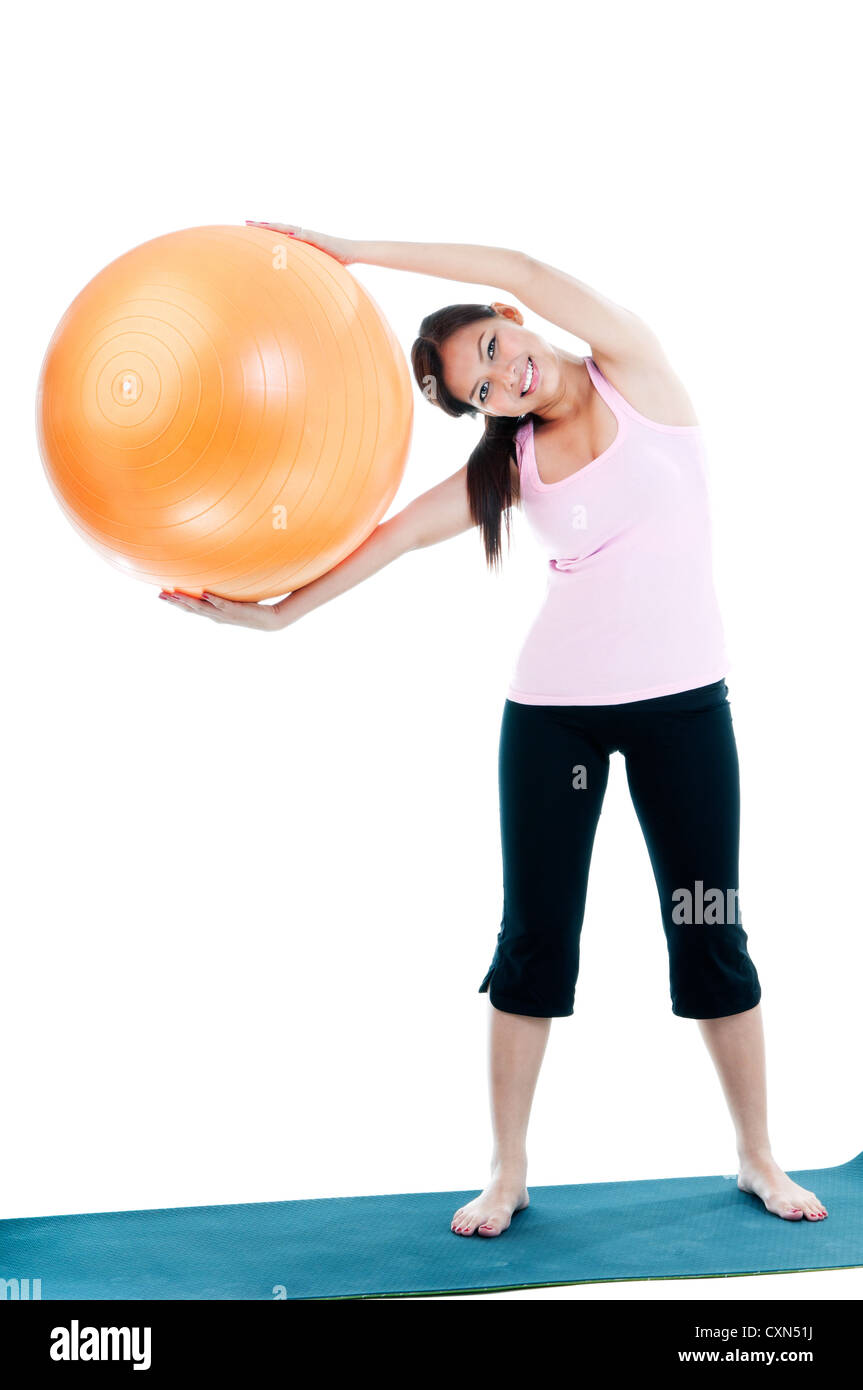 Cute young woman holding fitness ball Stock Photo - Alamy