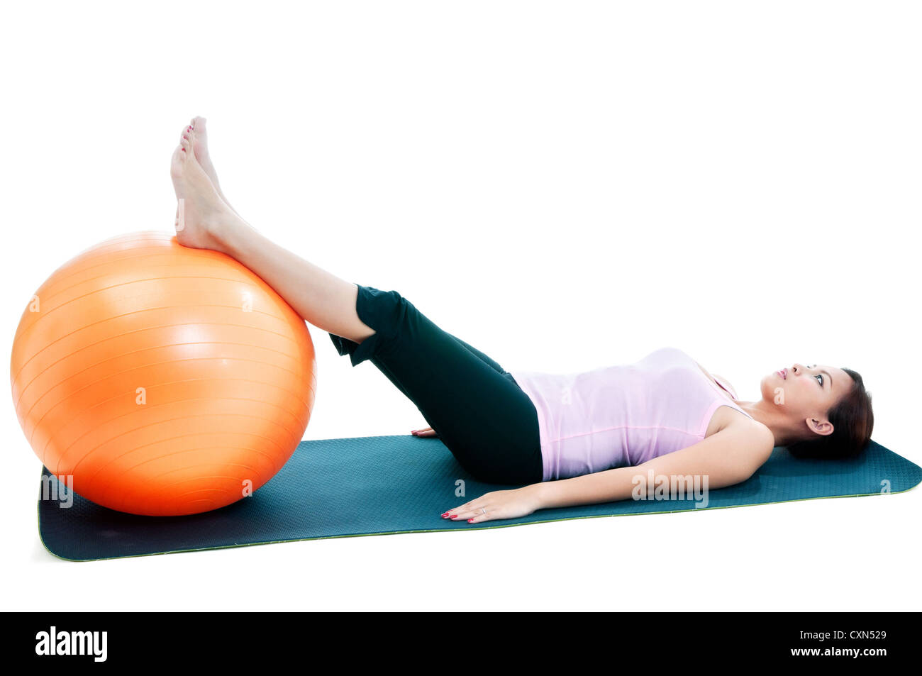 Fitness woman lying down with legs on balance ball Stock Photo Alamy