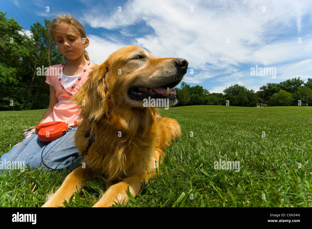 Young girl at park with pet Dog Stock Photo