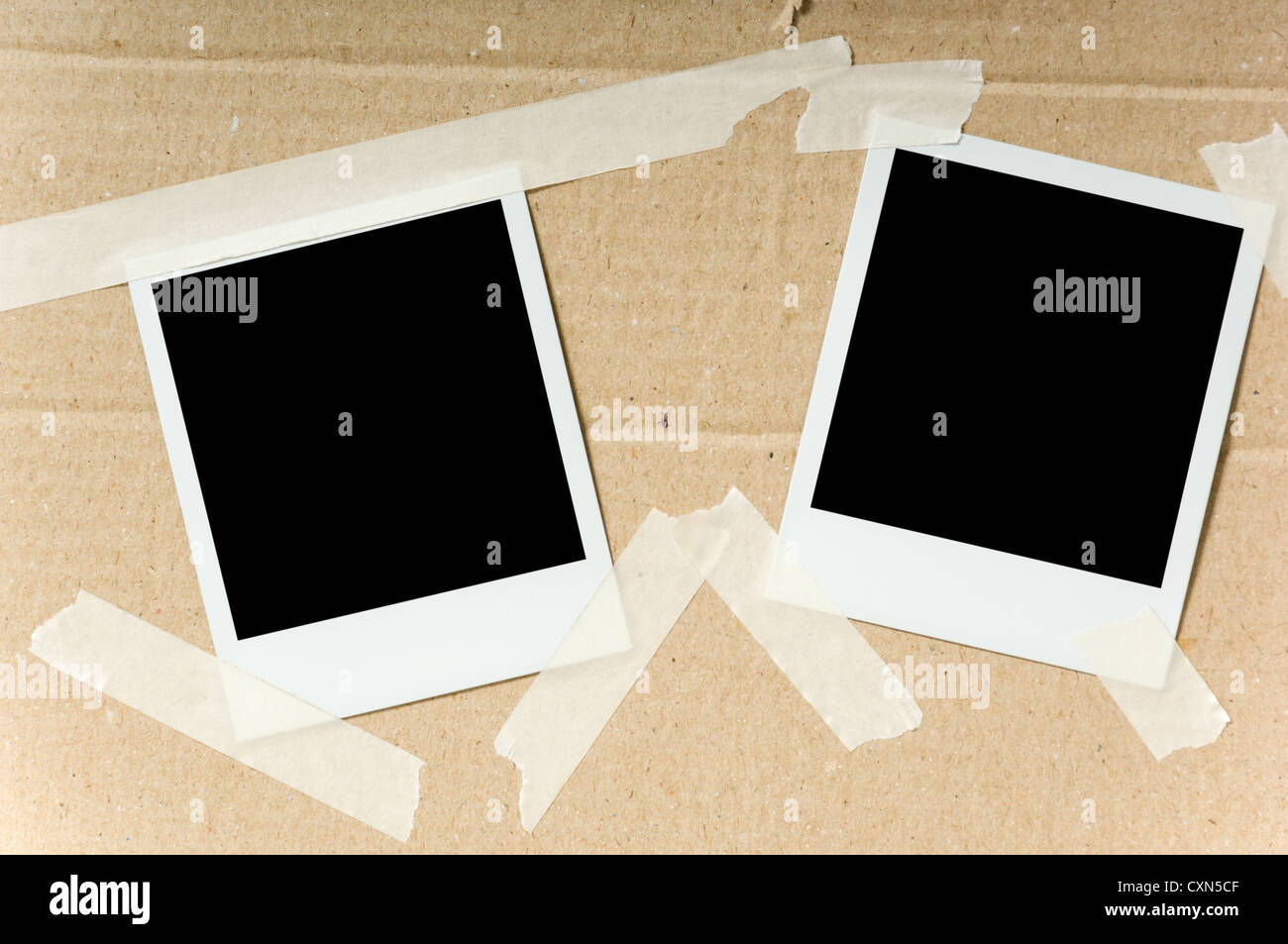 Two Polaroid Photographs Attached With Masking Tape To A Cardboard Stock Photo Alamy
