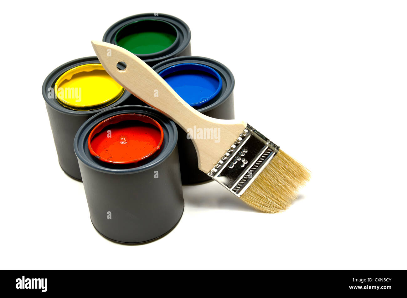 Four primary colored cans of paint with a paint brush on white background Stock Photo