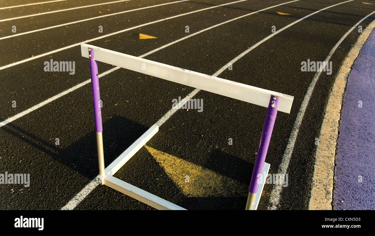 Running track with hurdle positioned for a race Stock Photo