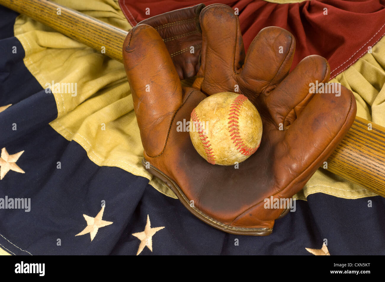 Antique baseball glove, ball and bat on vintage American flag inspired bunting Stock Photo