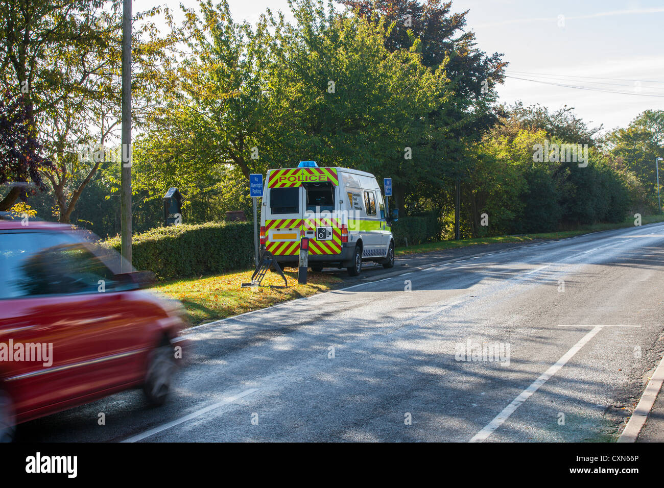 Car passing a mobile speed camera in village Stock Photo