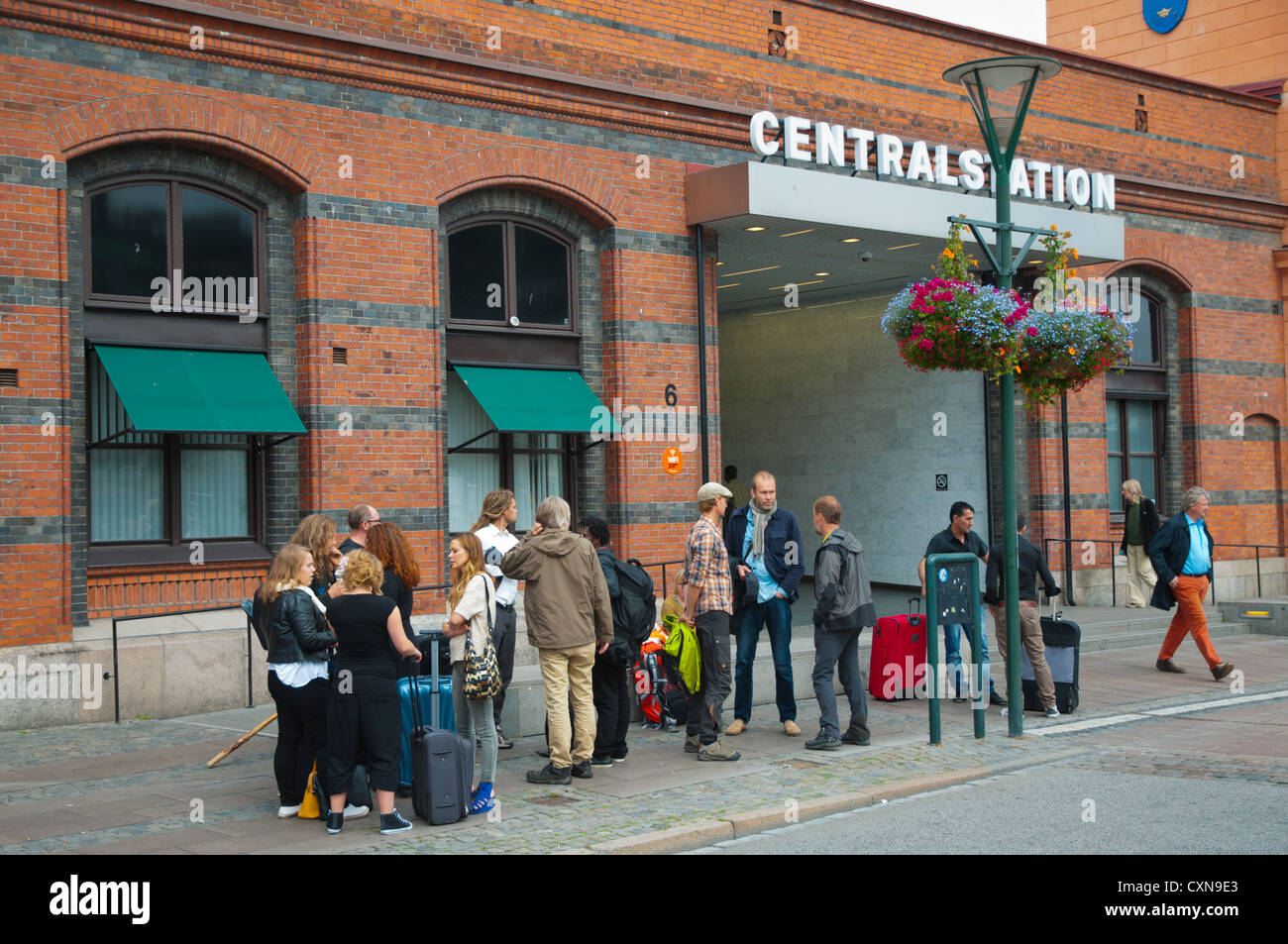Group of commuters outside Malmö centralstation the main railway station Malmö city Skåne county Sweden Europe Stock Photo
