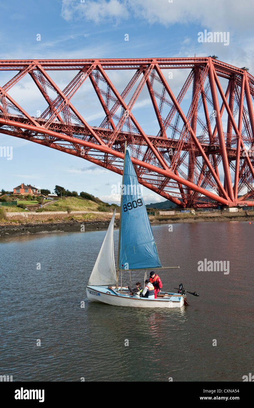 Sailing dinghy next to Forth railway Bridge Stock Photo