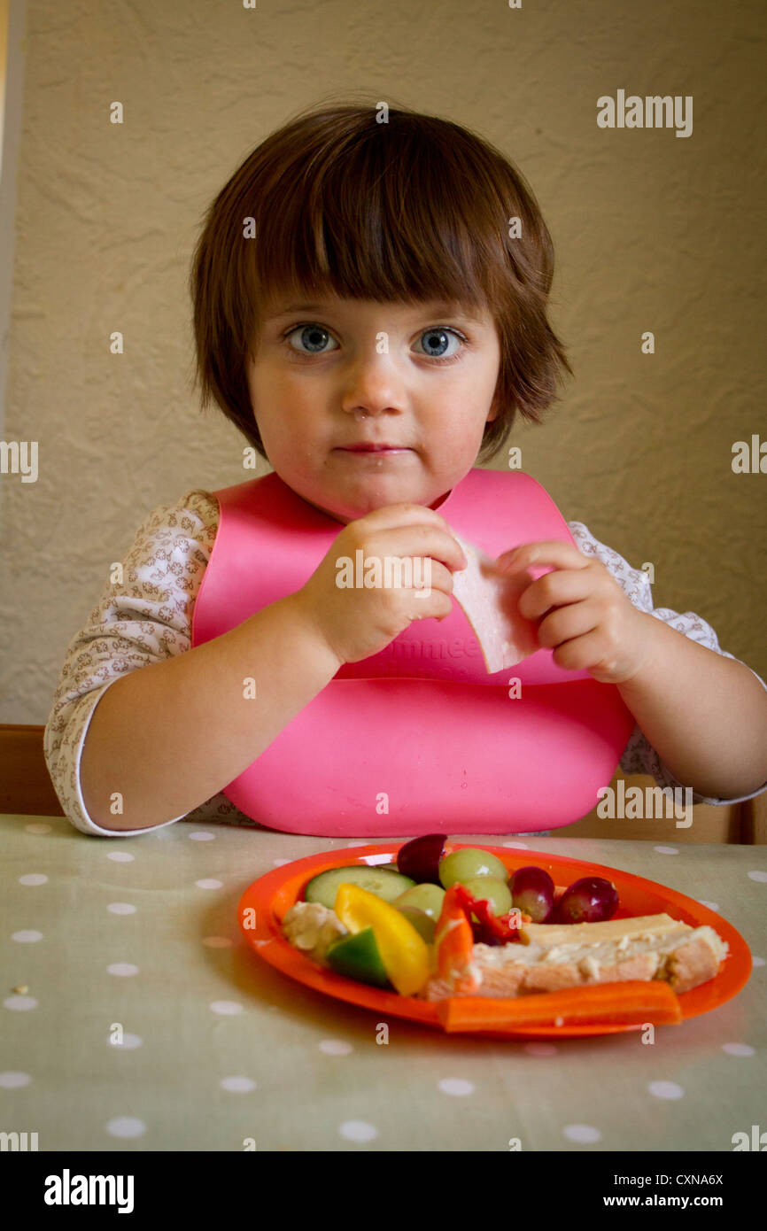 Four year old girl eating Stock Photo - Alamy