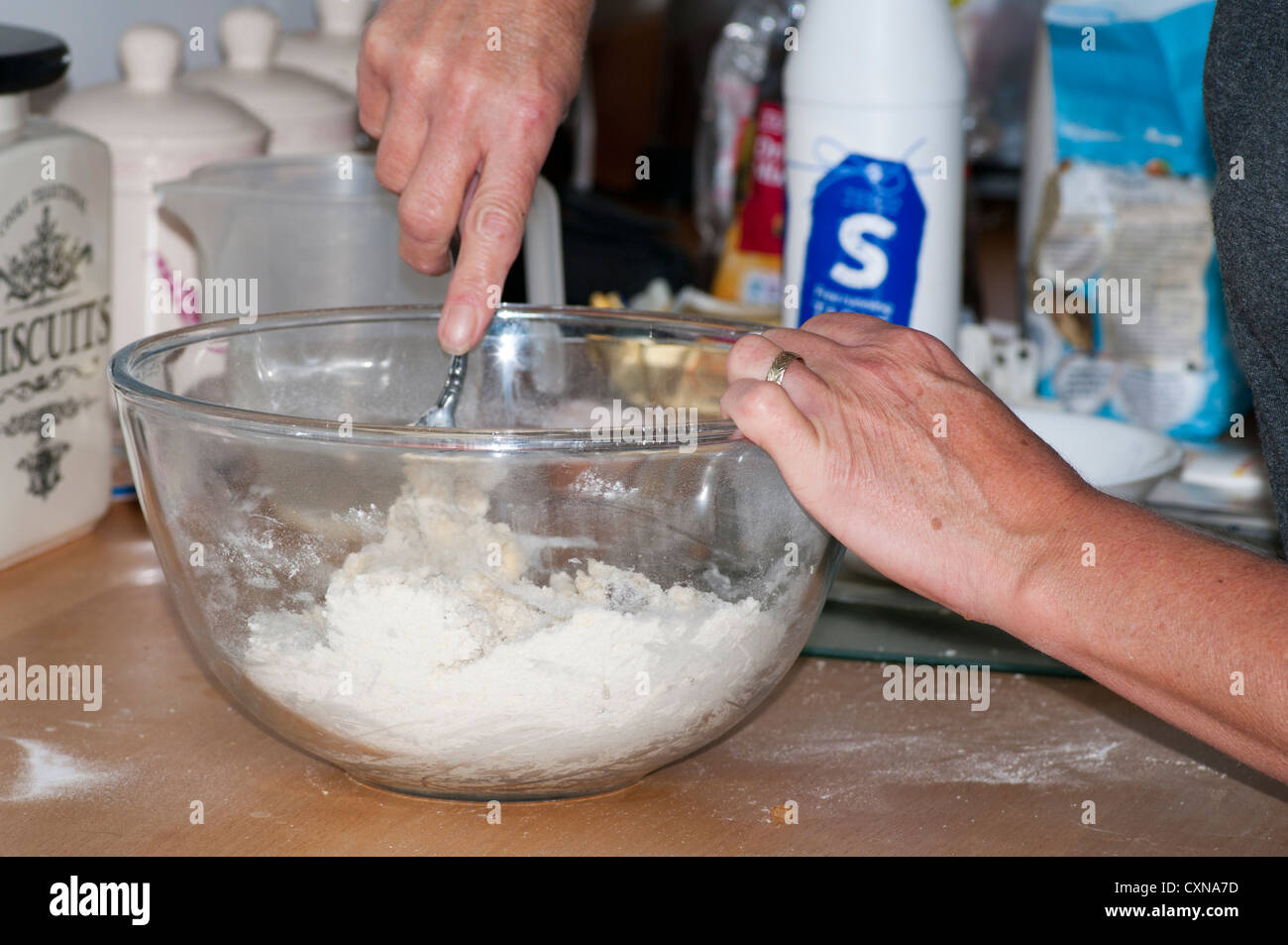 Cook Mixing Cake Mix In a Mixing Bowl Home Baking Stock Photo