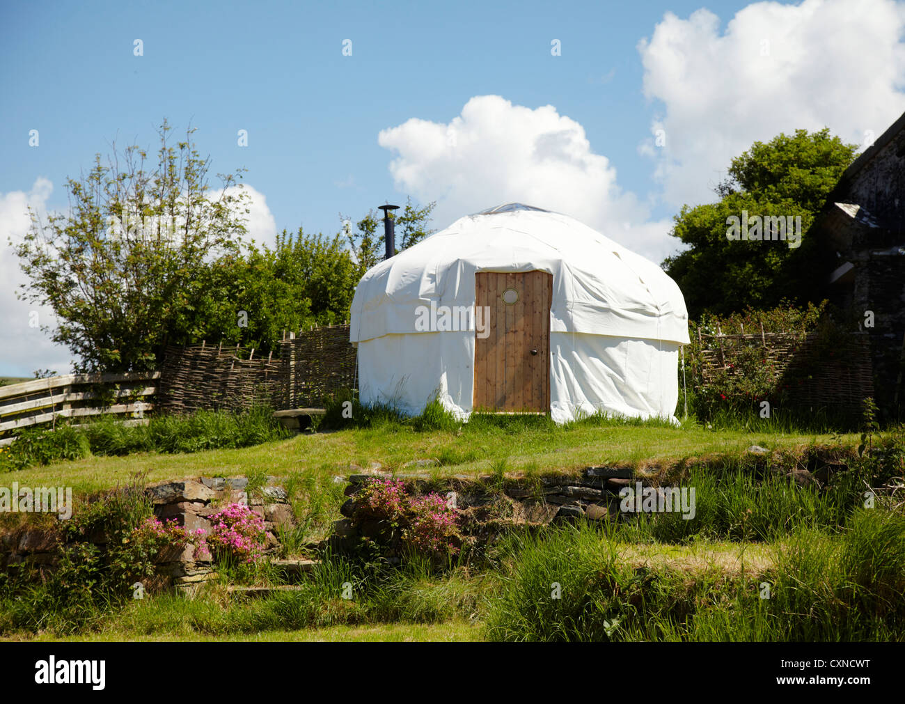 Hand made ten foot diameter yurt tent in garden setting Stock Photo