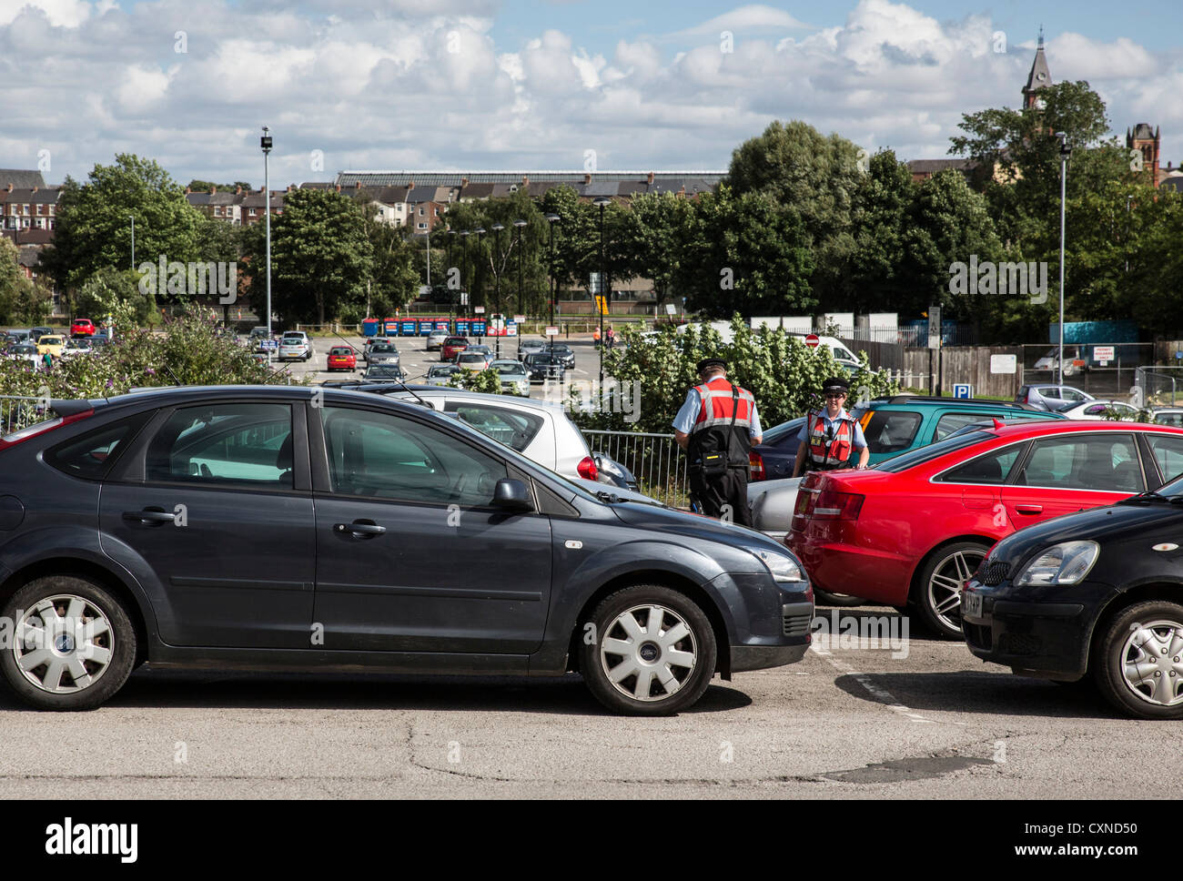 Wardens in a Darlington, UK, car park check cars to give penalty notices Stock Photo