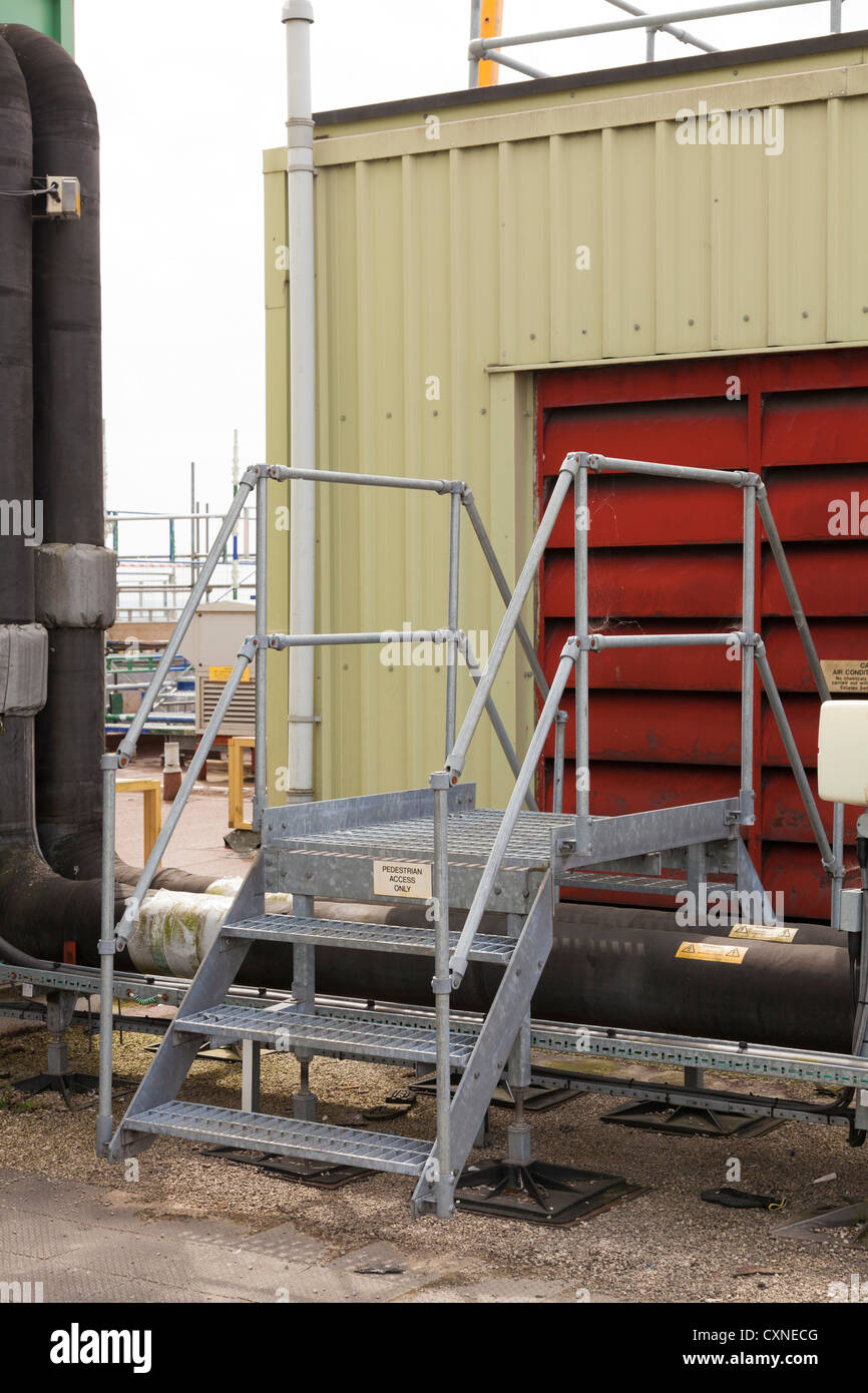 steps giving access over roof top industrial plant pipework Stock Photo