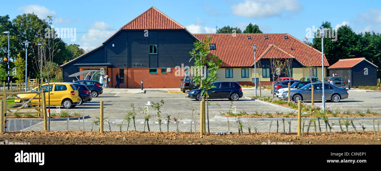 Car parking new purpose built NHS doctors surgery and Health Centre clinic serving villages with dispensary and Mother & Baby clinic Essex England UK Stock Photo