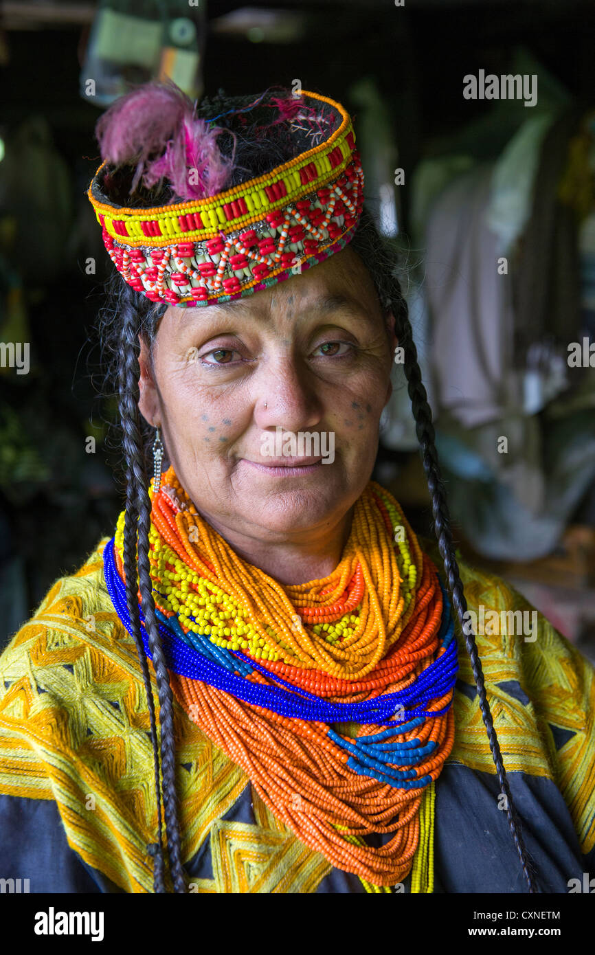 Kalash woman on the verandah of the oldest house in the valley, Kalasha Grum village, Rumbur Valley, Chitral, Khyber-Pakhtunkhwa, Pakistan Stock Photo