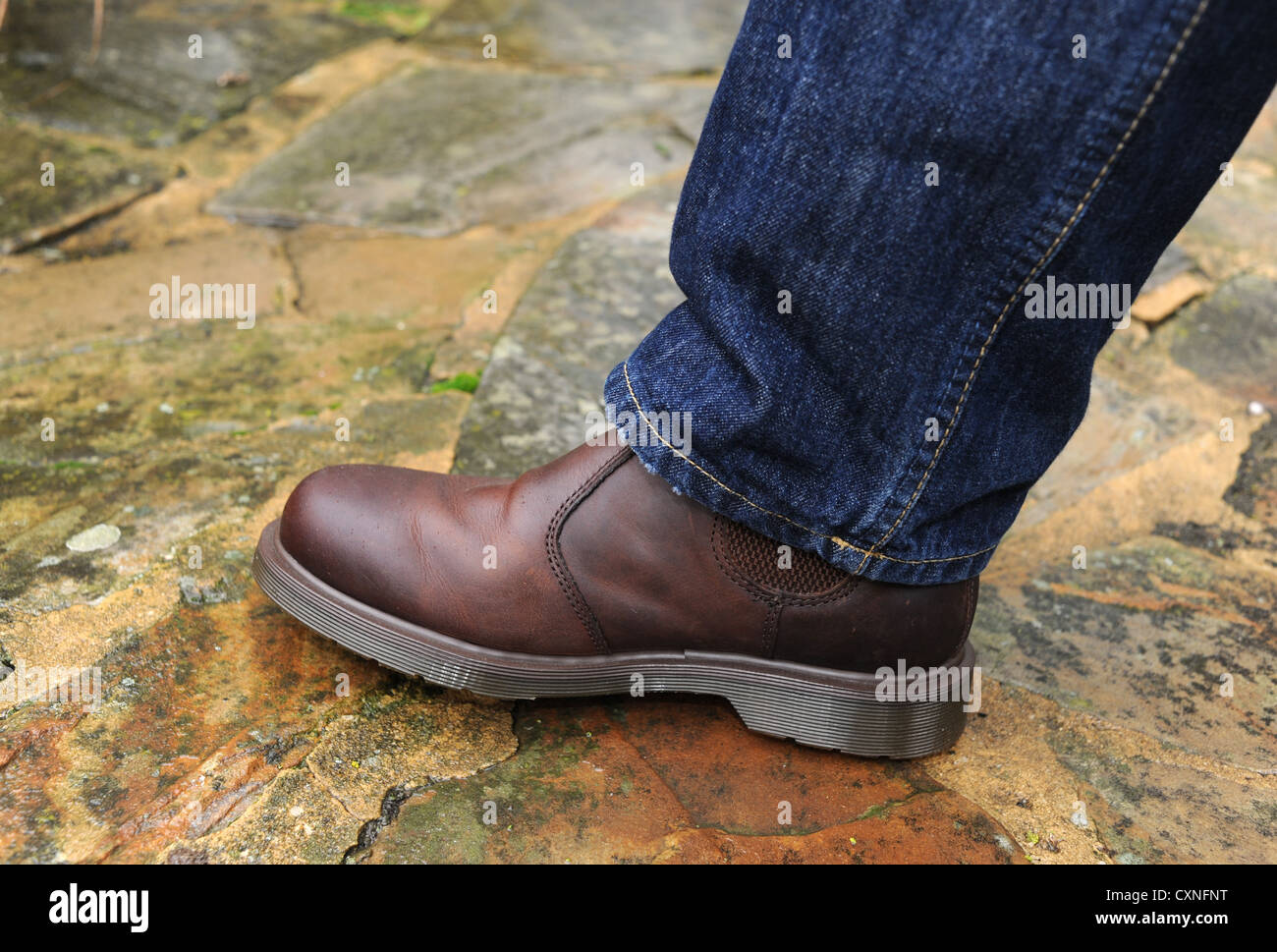 Brown leather Doc Martens boots and blue jeans fashion footwear Stock Photo  - Alamy