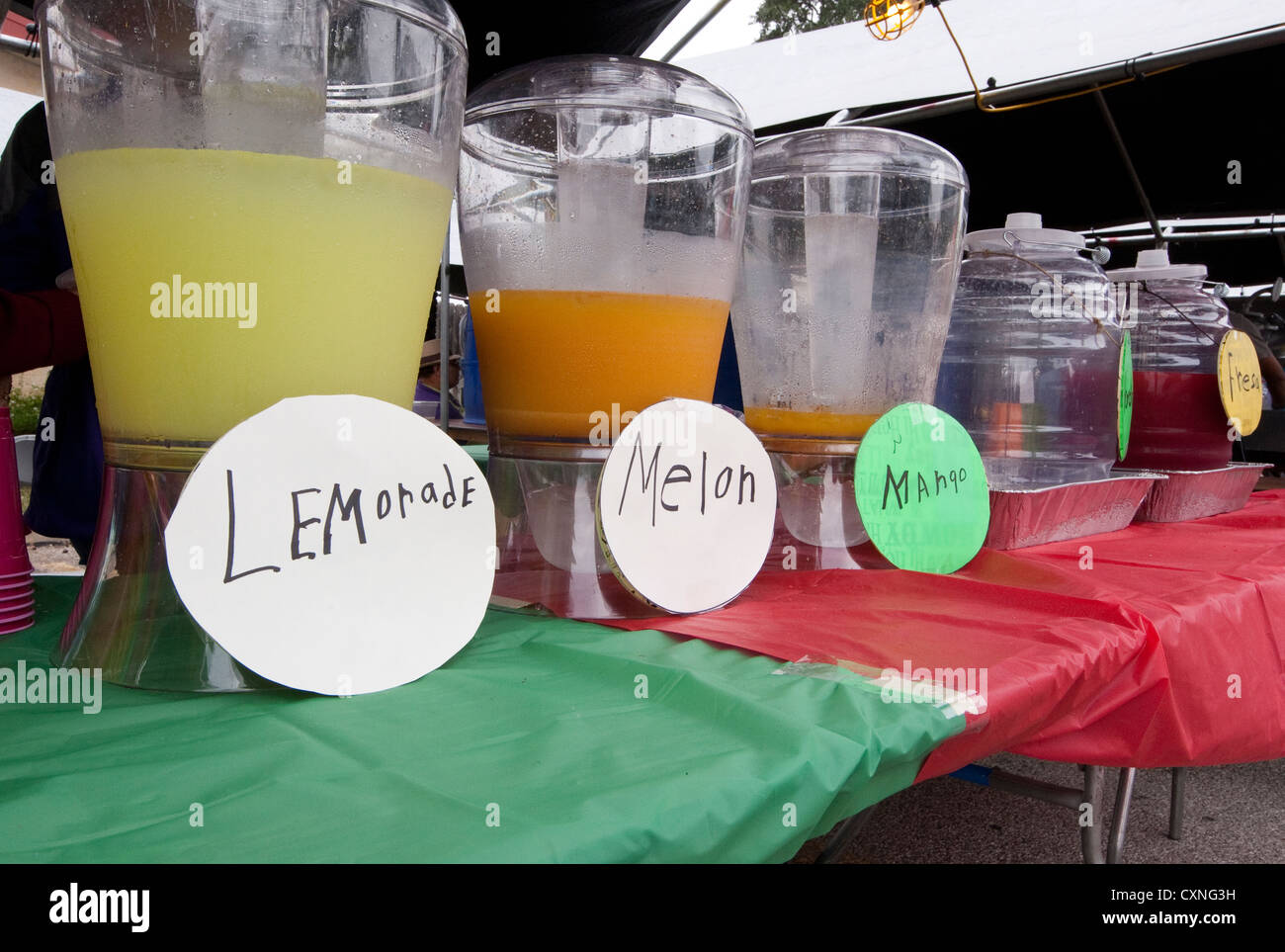 Jugs full of fruit flavored water at a food booth during Catholic church outdoor festival in Austin, Texas Stock Photo