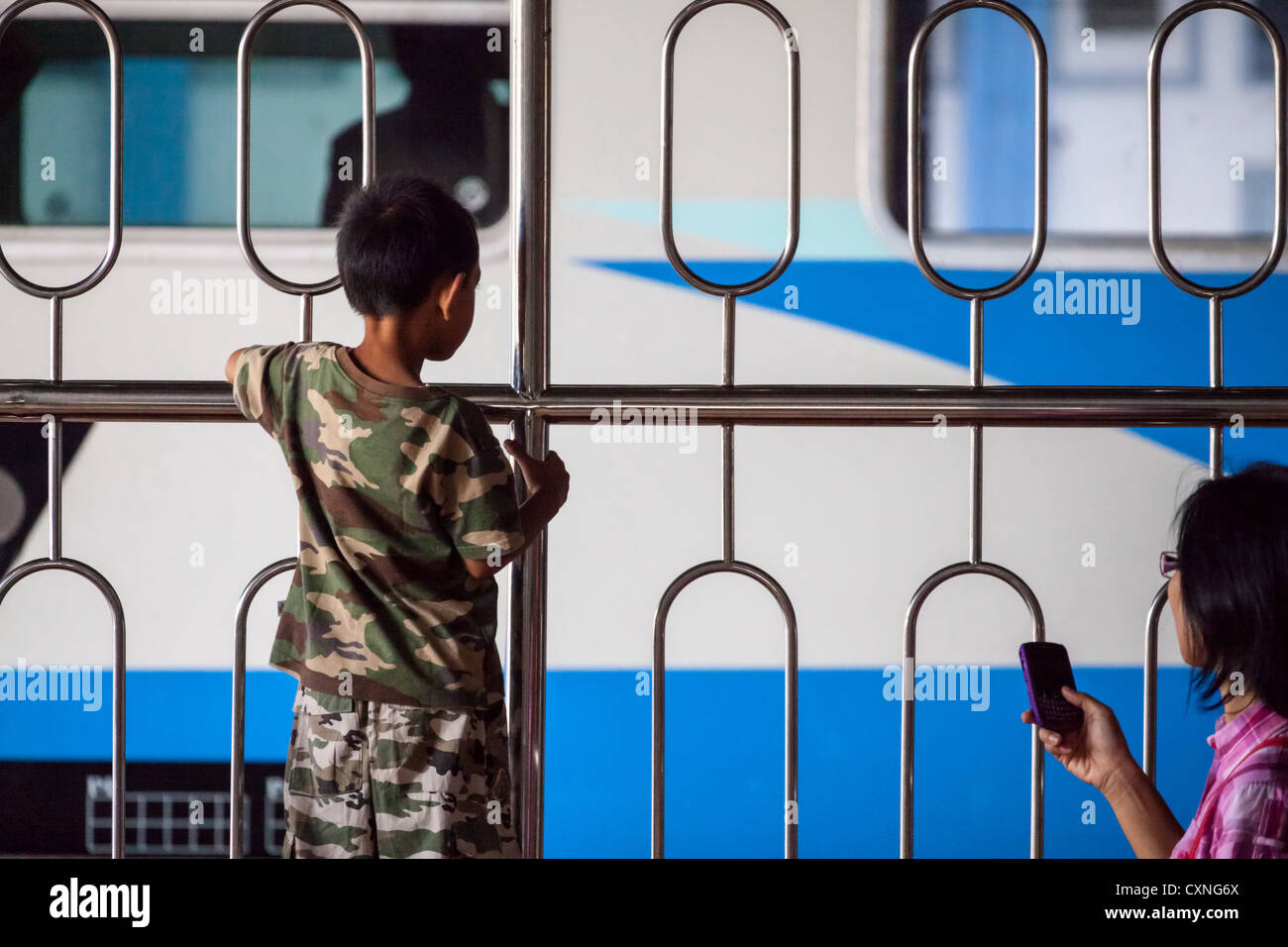 Little Boy looking at a Train at the Railway Station in Yogyakarta in Indonesia Stock Photo