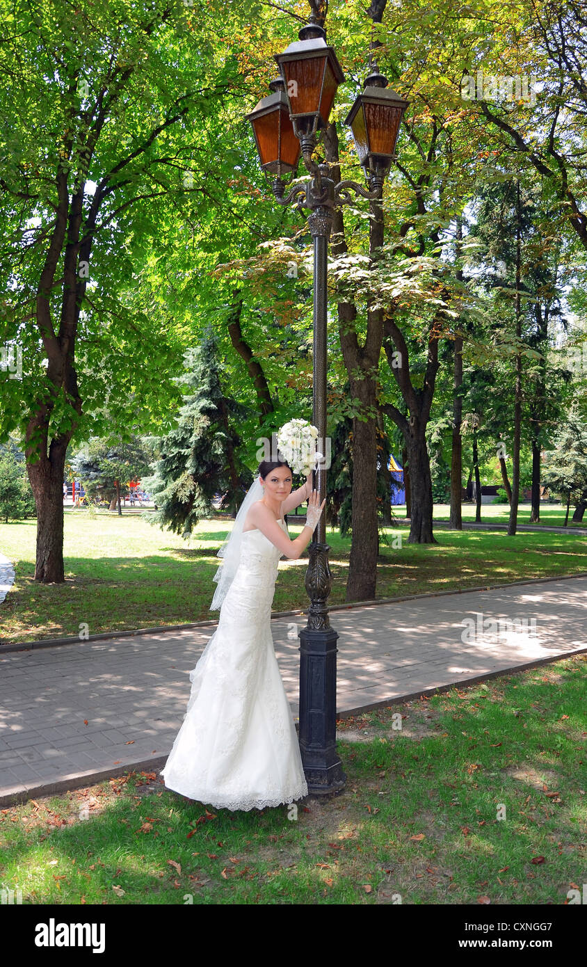 beautiful bride with a bouquet on nature Stock Photo - Alamy