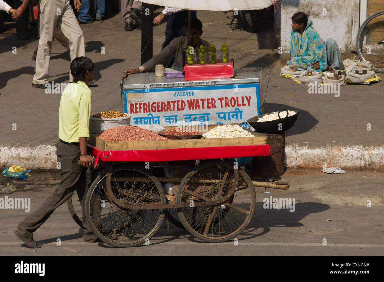 Mobile food cart passing a refrigerated water trolley on Chandni Chowk